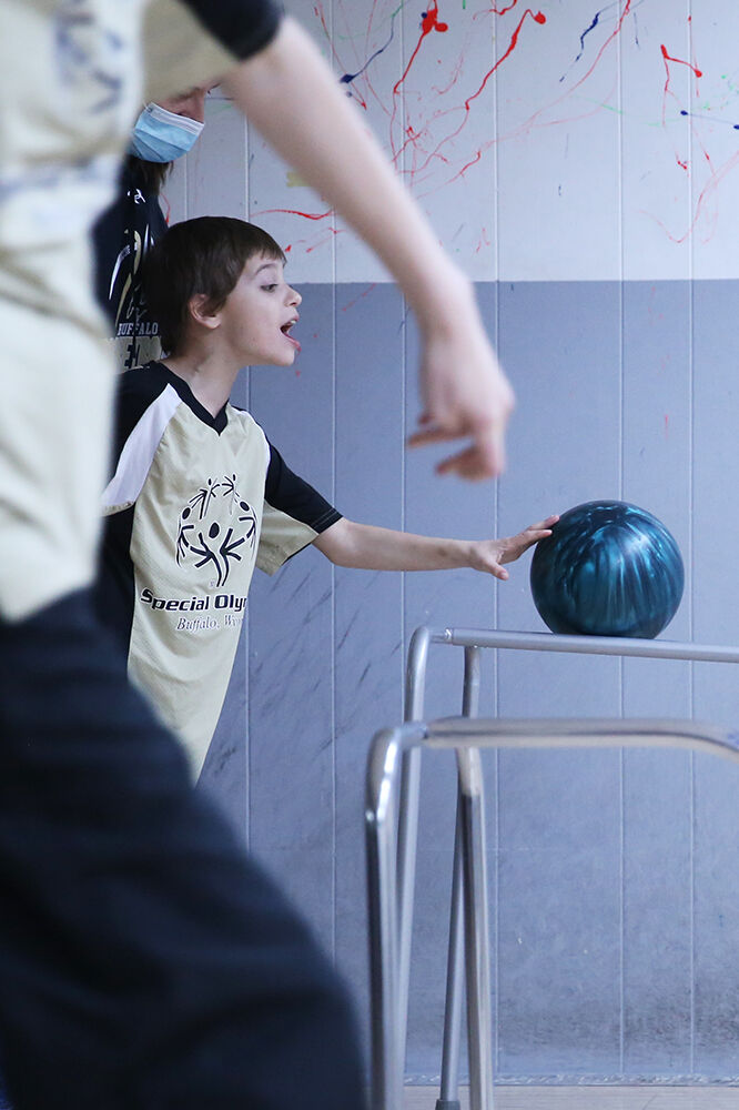 Gage Jarvis pushes his ball down the bowling ramp